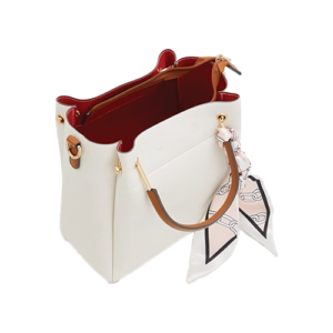 Leather and Kids white leather bucket bag open showing red interior lining and tan handle