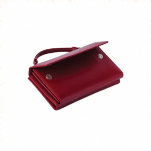 Angled view of the Red Leather Wristlet Clutch Wallet showing the raised wrist loop and flap closure edge.