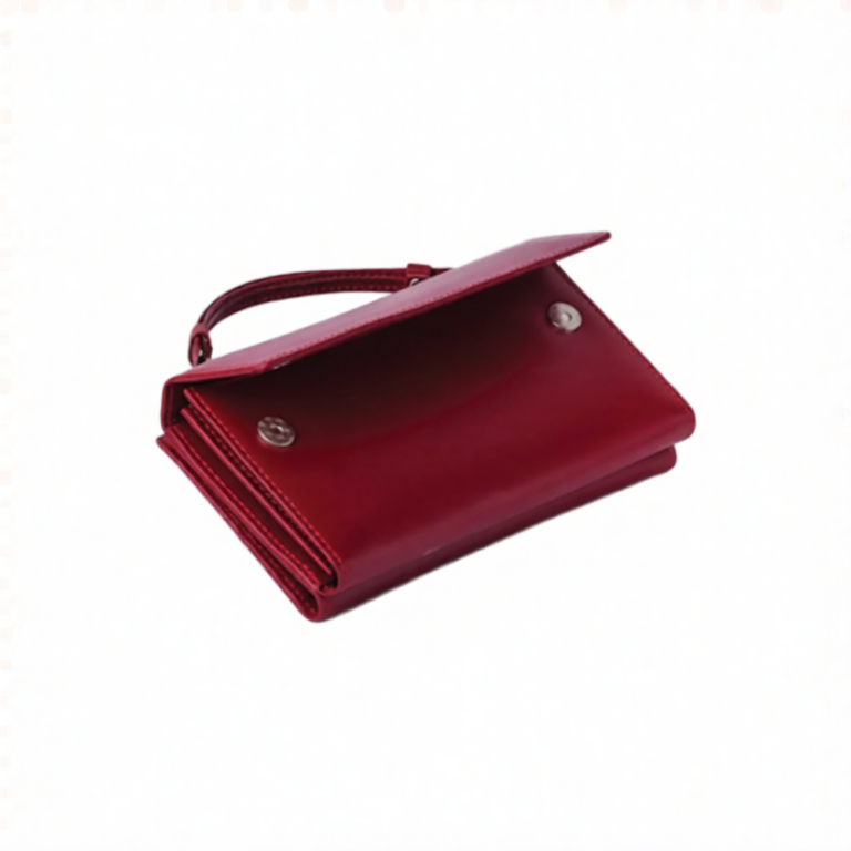 Angled view of the Red Leather Wristlet Clutch Wallet showing the raised wrist loop and flap closure edge.
