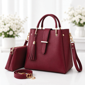 Leather and Kids maroon leather handbag set with tassel detail and matching pouch on floral backdrop